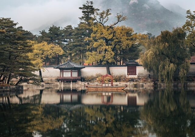 asian temple next to lake
